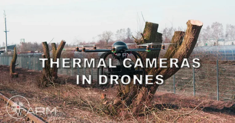 a drone flying on the field with thermal camera below it capturing everything